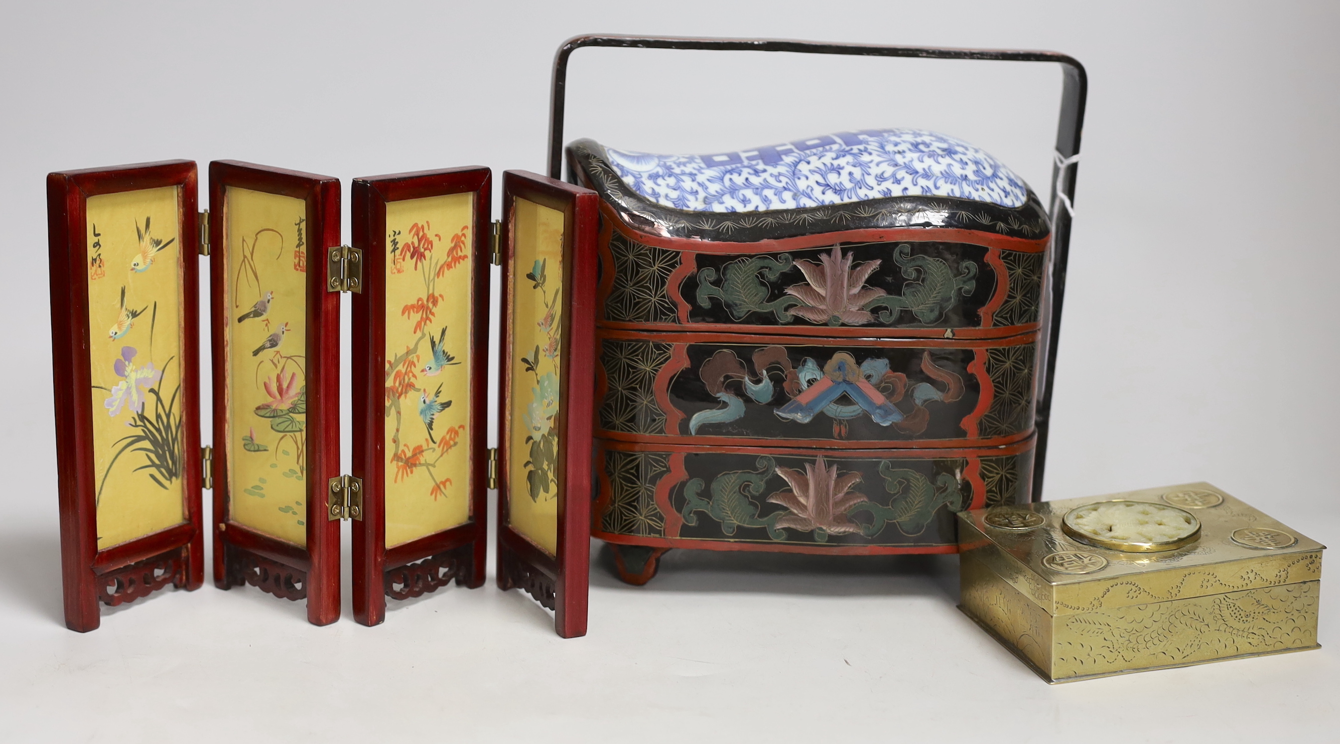 A Chinese lacquer and porcelain inset three tier stacking box, together with a hardstone inset brass box and miniature screen